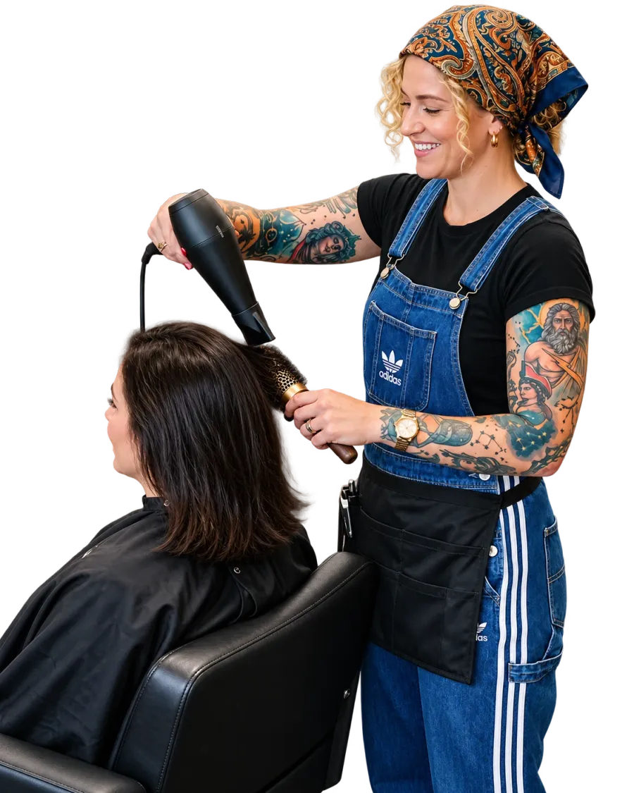 A stylist blow-drying a client’s hair, both hands busy.