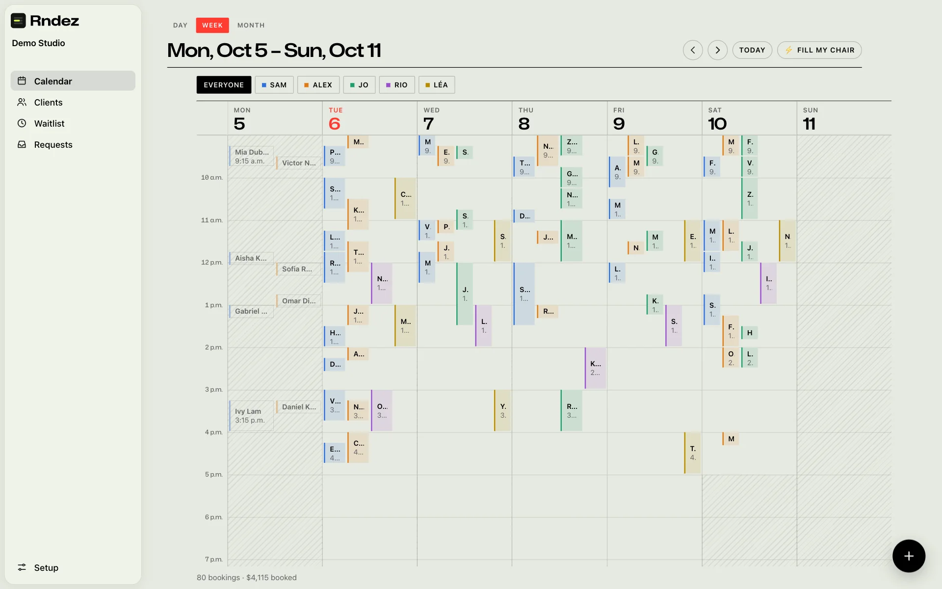 The owner dashboard Week view on a computer, full of bookings coloured by staff member.